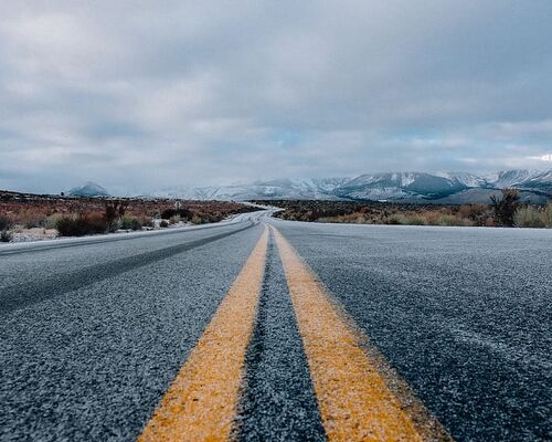 landscape-photography-of-asphalt-road-under-cloudy-sky-during-daytime